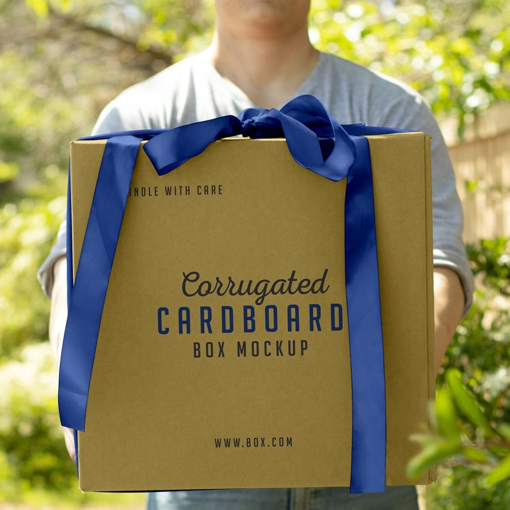 Download Free Hand Holding Corrugated Cardboard Box Mockup PSD ...